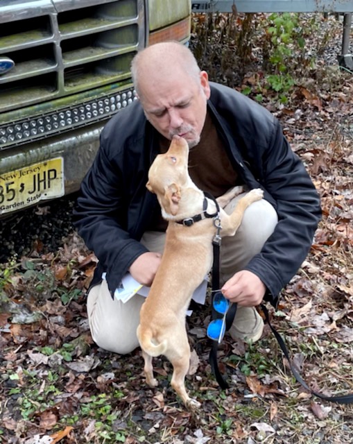 Mark Winkler kisses his dog Jake